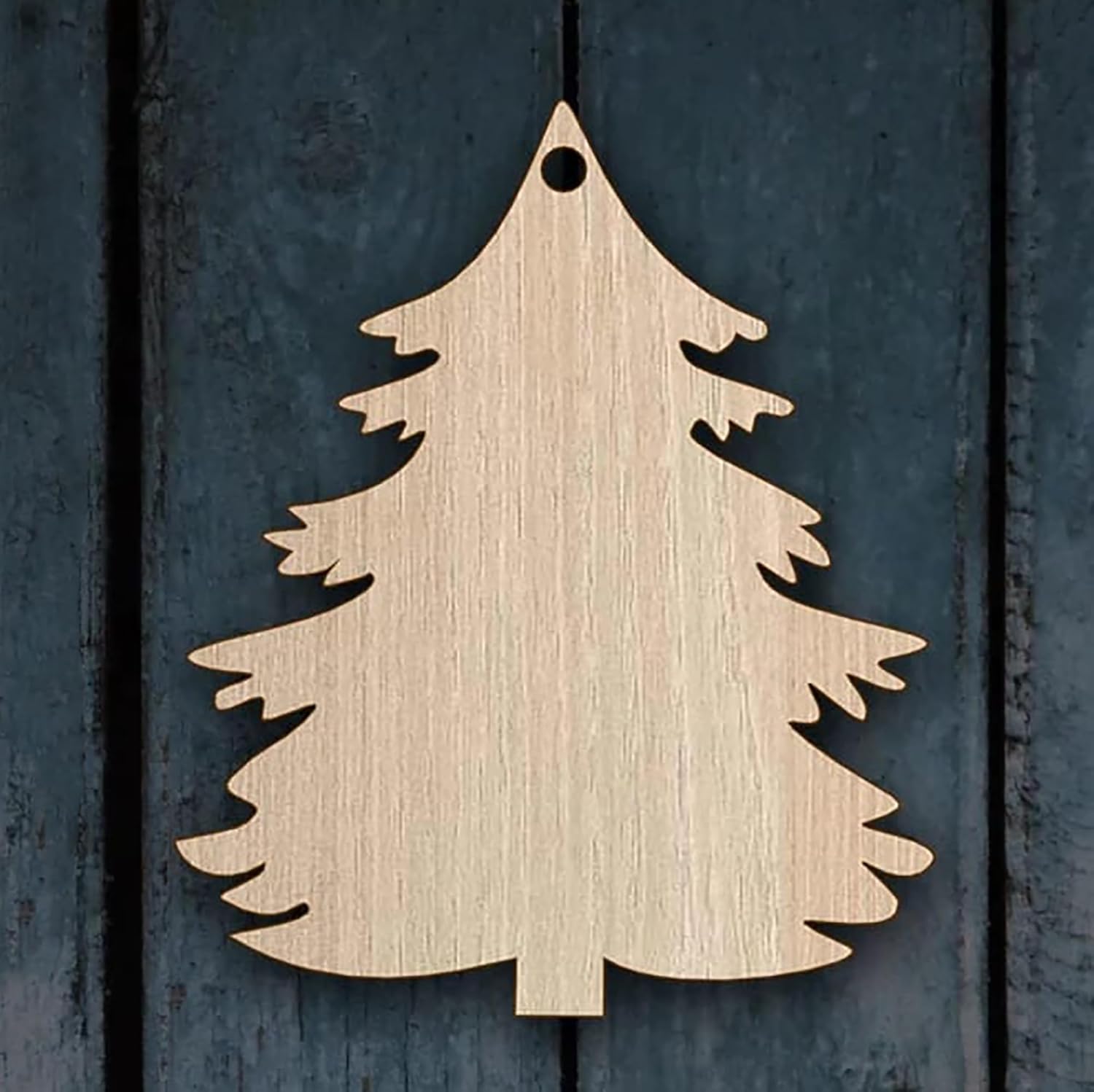 Wooden Christmas tree decoration on a dark wooden background