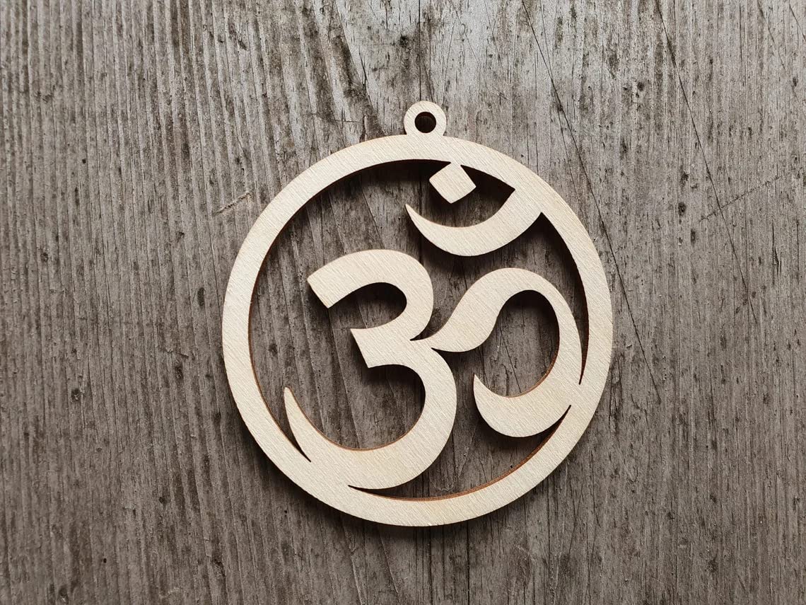 Wooden pendant with Om symbol on a wooden background