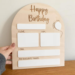Wooden birthday card with text and space for writing on a wooden surface.