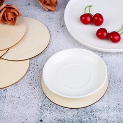 White ceramic plate with gold rim on a textured surface with cherries and flowers.