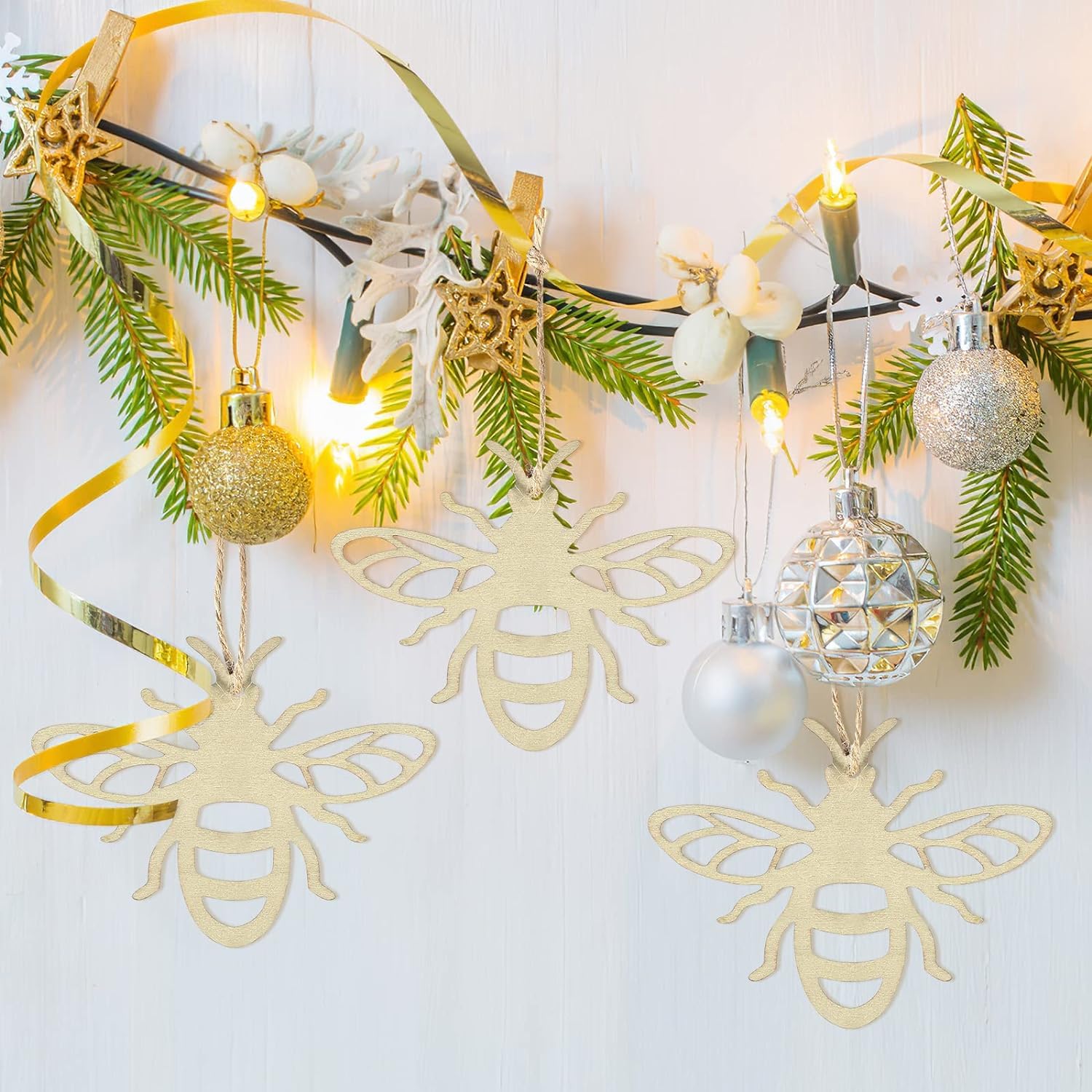 Decorative wall hanging with bees, ornaments, and lights on a white background