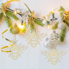 Decorative wall hanging with bees, ornaments, and lights on a white background