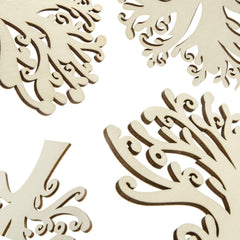 Decorative wooden pieces with intricate cut-out patterns on a beige background