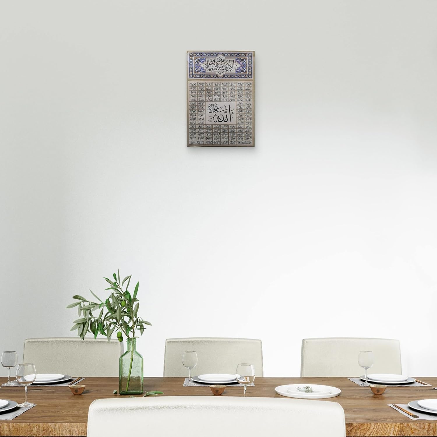 Dining room with a table set for four, a vase with greenery, and a decorative wall piece.