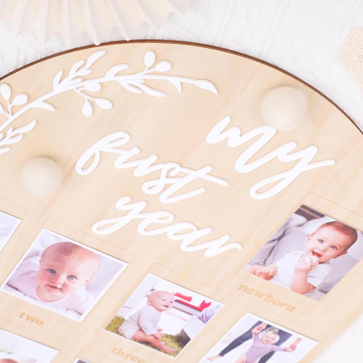 Memorial photo album titled 'My First Year' with baby photos on a light background
