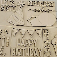 Wooden birthday-themed cutouts with phrases like 'Happy Birthday' and 'Birthday wishes'.