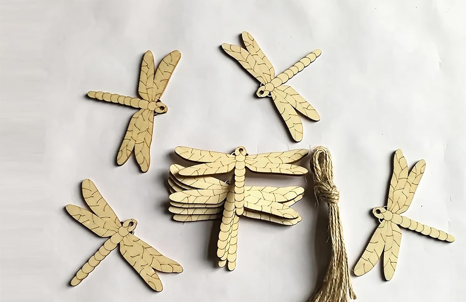 Dragonfly-shaped wooden ornaments on a white background