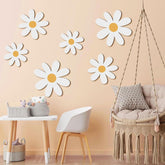 Children's room with daisy wall decals, a swing chair, and small table.