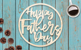 Wooden 'Happy Father's Day' sign on a blue wooden background with pinecones and a coffee cup.