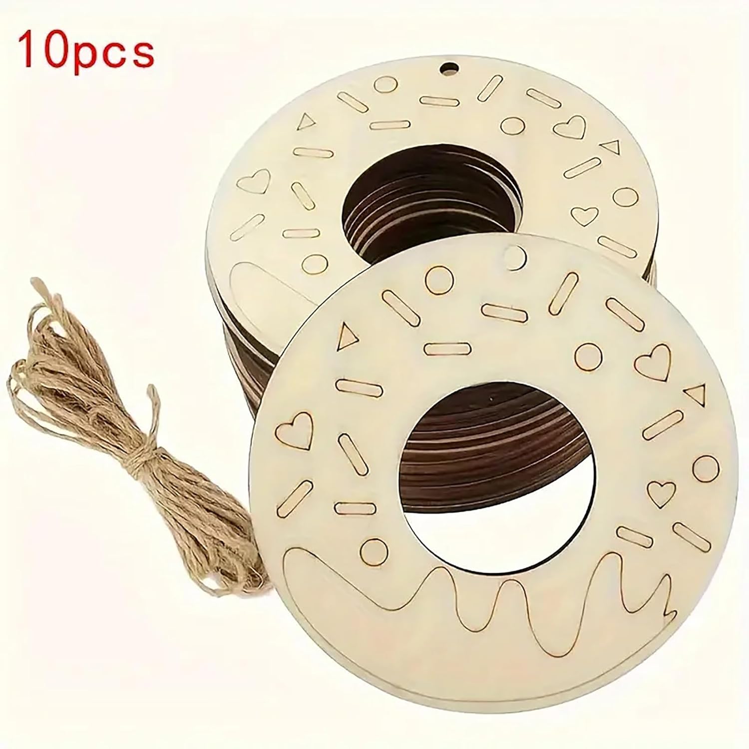 Two wooden spools with decorative patterns and a string on a white background.