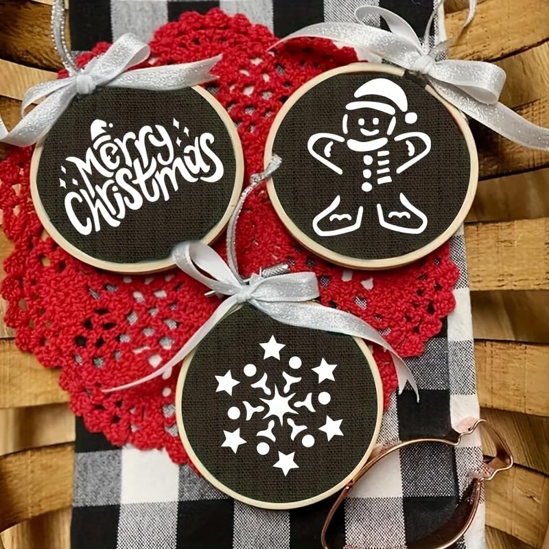 Decorative Christmas ornaments with embroidered designs on a red and black checkered fabric background.