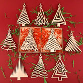 Wooden Christmas tree ornaments on a red background with greenery.