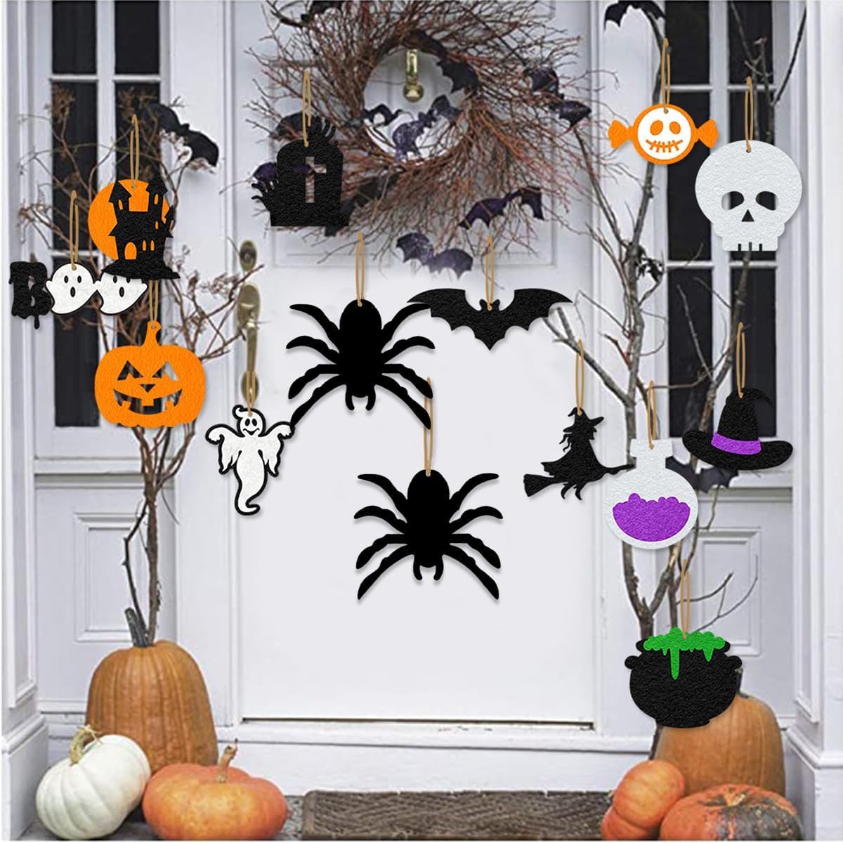 Halloween decorations including pumpkins, spiders, and decorative items on a white door.