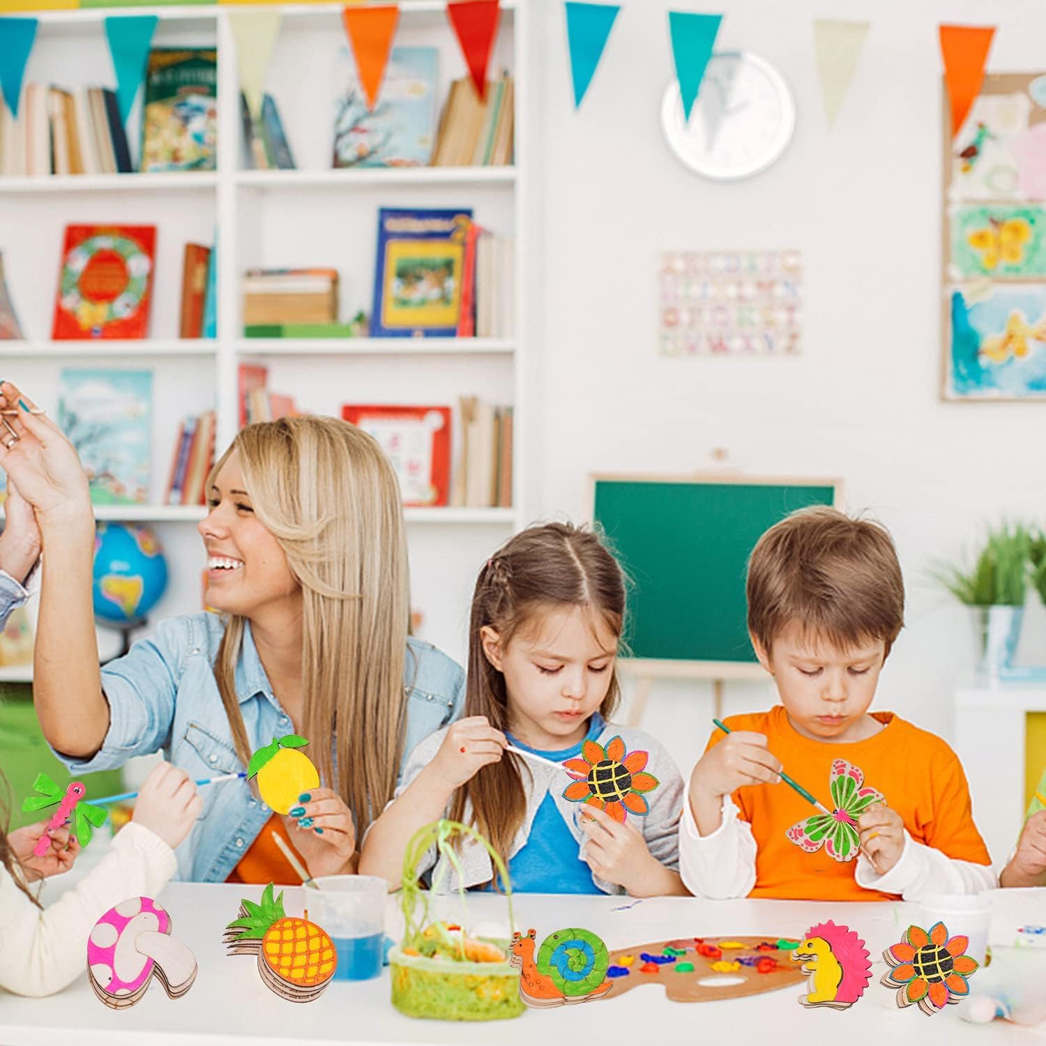 Teacher and students in a classroom making crafts with colorful materials
