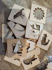 Set of wooden stencils with various shapes on a stone surface