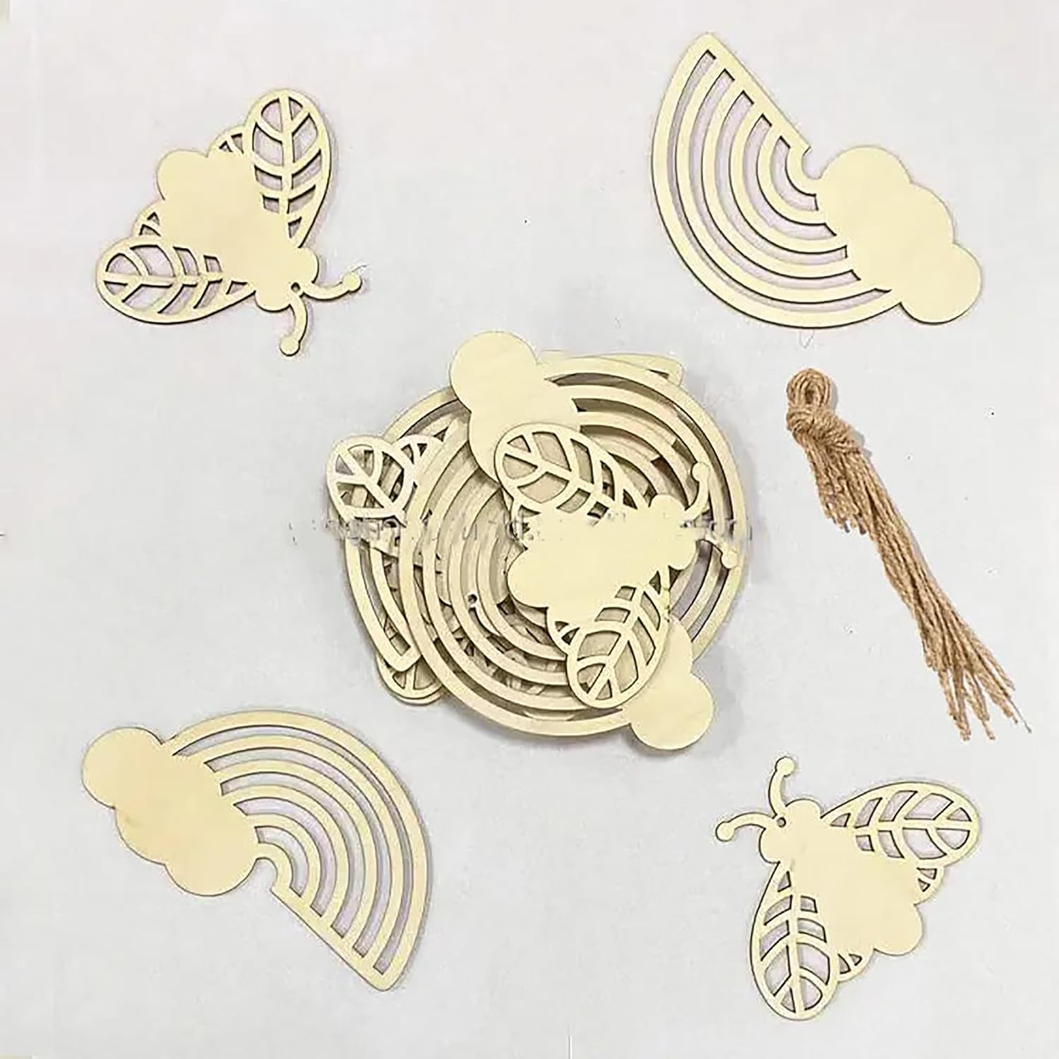 Set of decorative wooden cutouts with butterfly and rainbow designs on a light gray background.