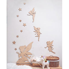Wooden fairy wall decals on a white wall with decorative items below.