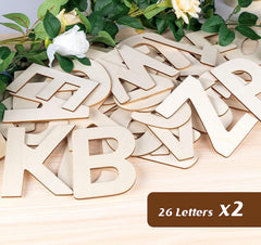 Wooden letters on a wooden surface with flowers in the background