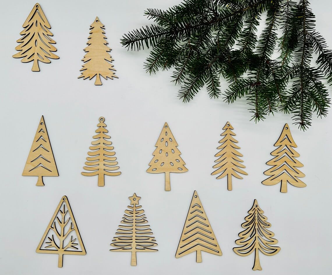 Wooden Christmas tree ornaments on a white background with greenery.