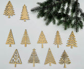 Wooden Christmas tree ornaments on a white background with greenery.