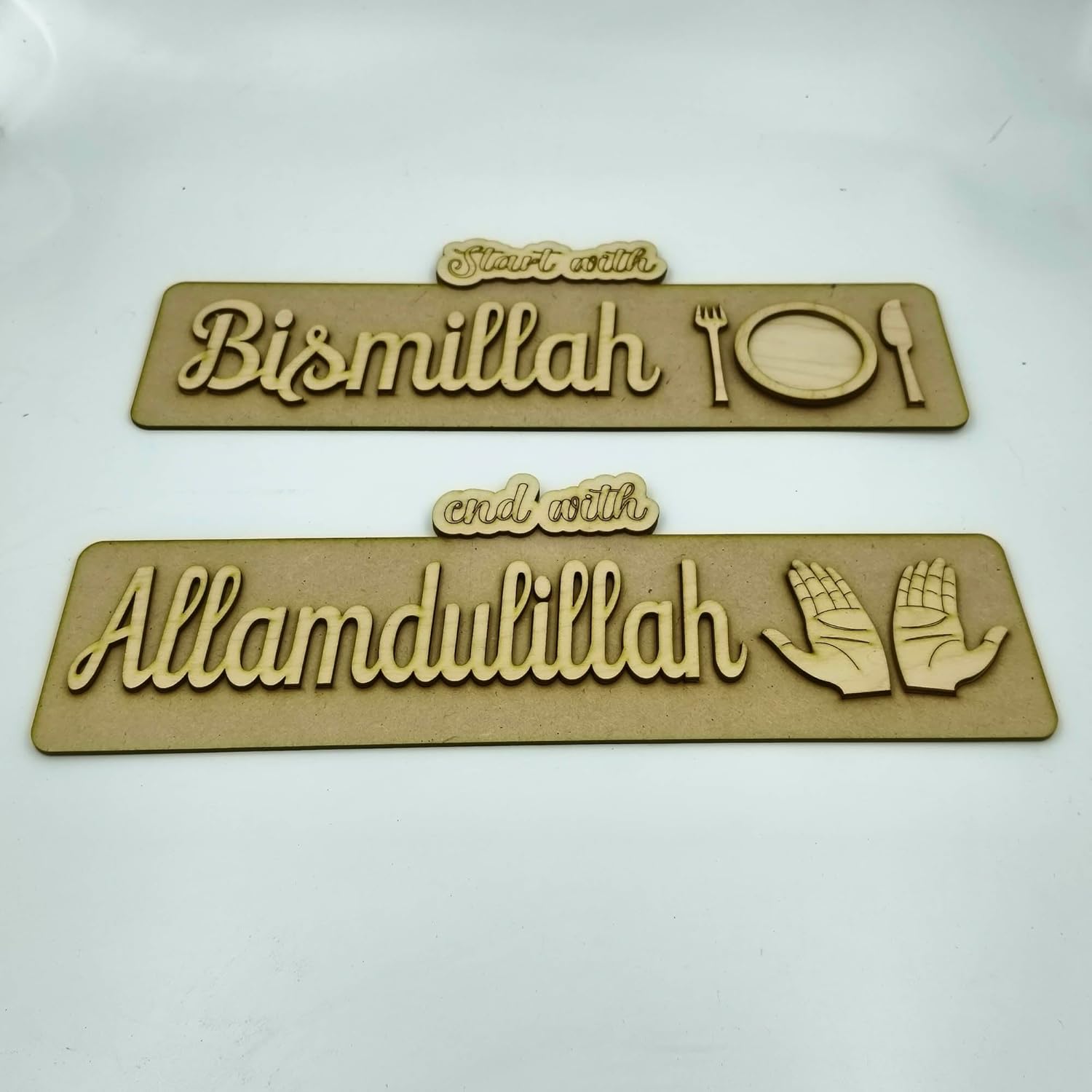 Two wooden plaques with engraved text and symbols on a white background