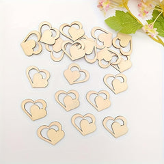 Gold heart-shaped decorations on a white surface with flowers in the background