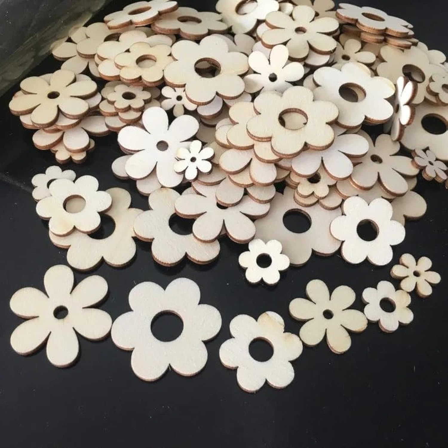 Wooden flower-shaped cutouts on a black background