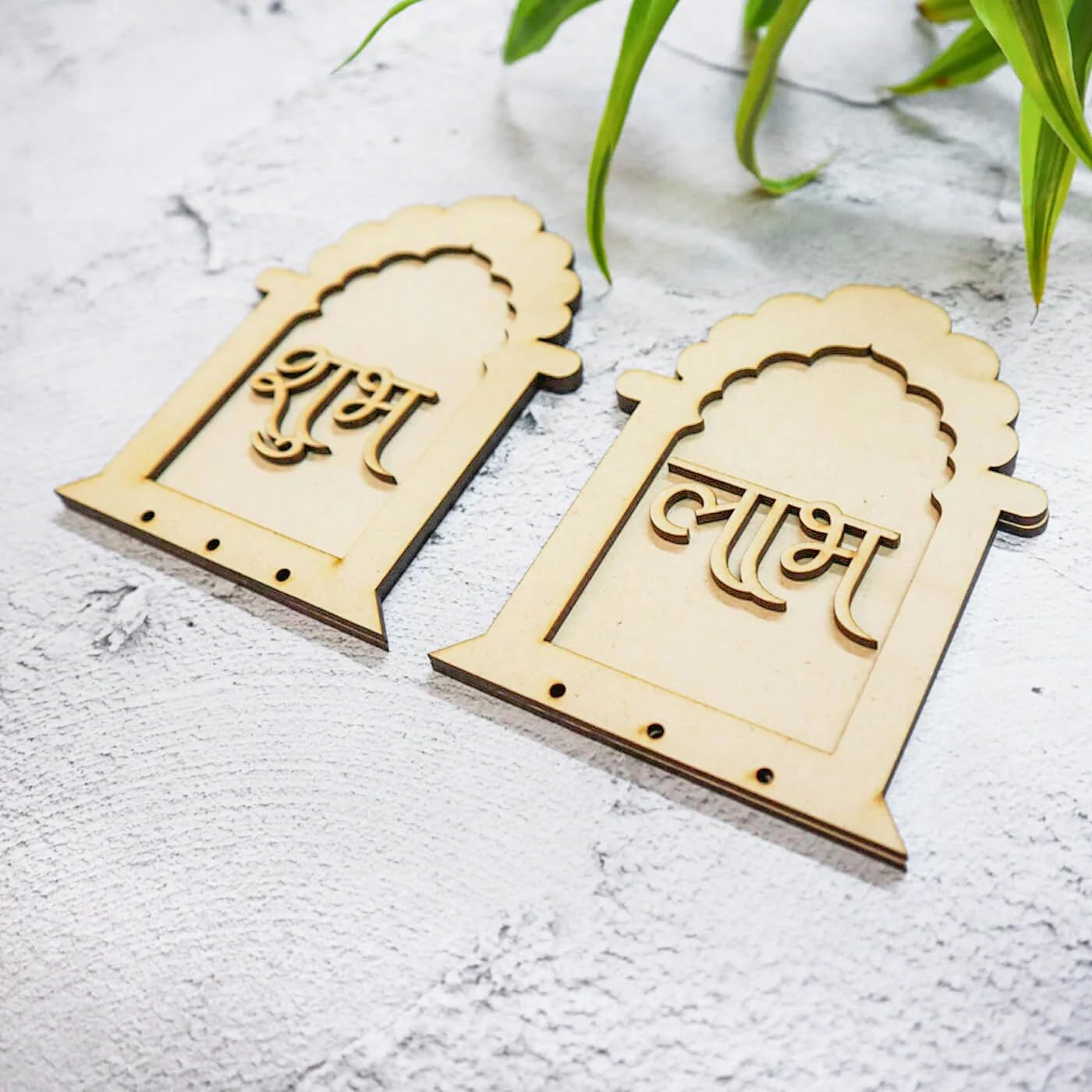 Two wooden nameplates with engraved text on a light gray surface.