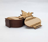 Wooden decorative item with intricate carvings on a white background