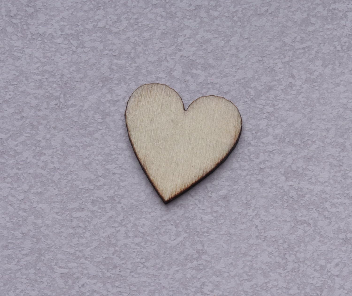 Wooden heart shape on a gray background