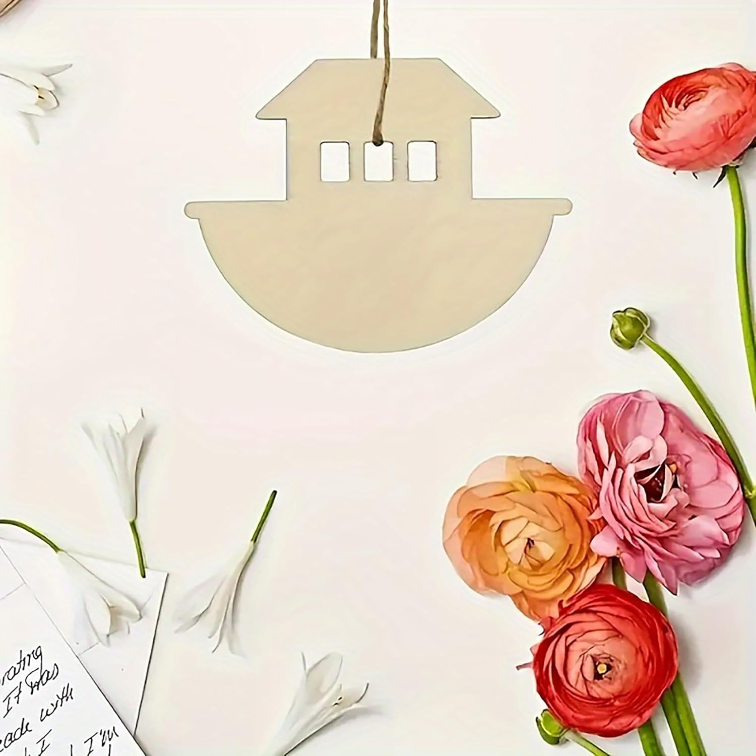 Decorative house-shaped tag with flowers on a light background