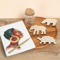 Wooden tray with animal cutouts, a notebook, and pencil on a wooden surface.