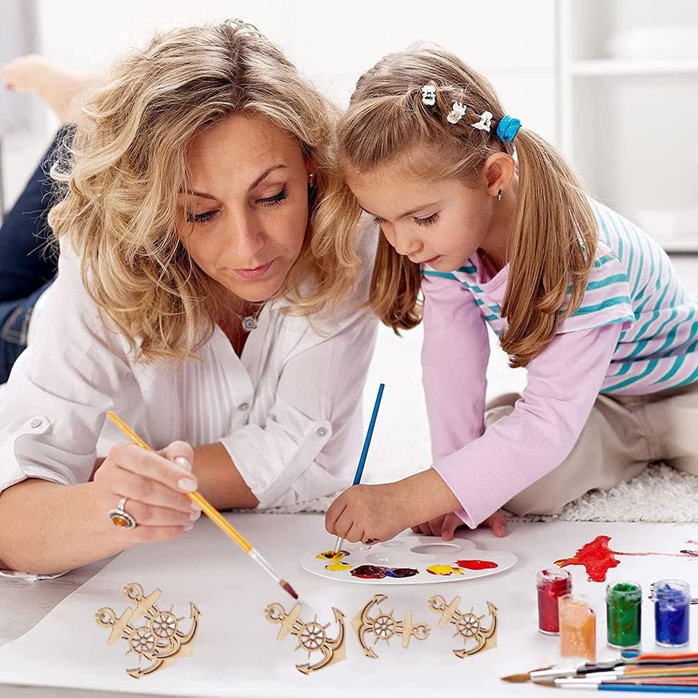 Woman and young girl painting together on a table with art supplies.