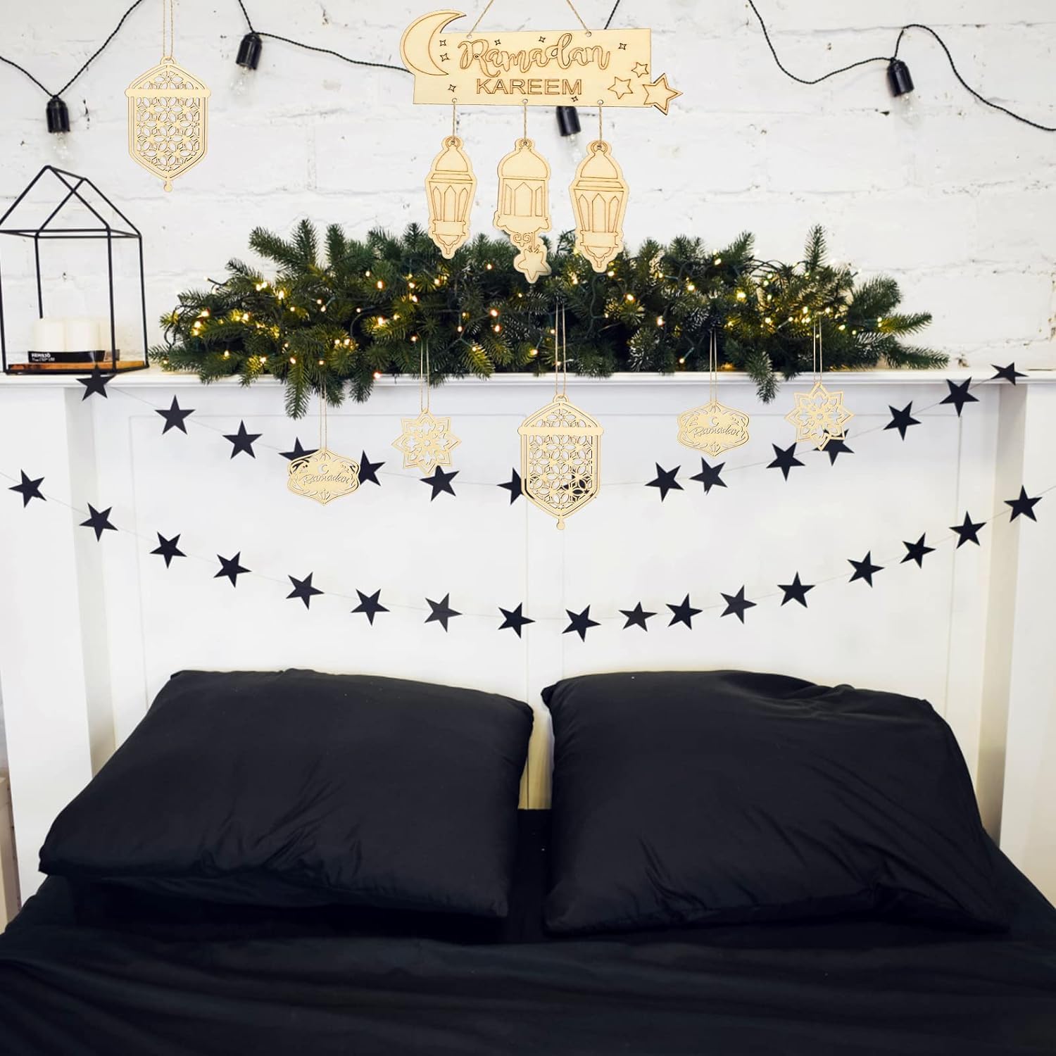 Decorated room with Christmas tree, lanterns, and star garlands on a white wall.