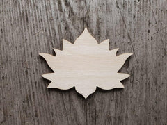 Wooden leaf-shaped cutout on a wooden surface