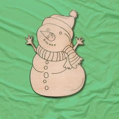 Wooden snowman decoration on a green fabric background