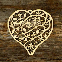 Decorative heart-shaped cutout with intricate patterns on a wooden surface