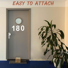 Door with number '180' and plant on a blue carpet, text 'EASY TO ATTACH' at the top.