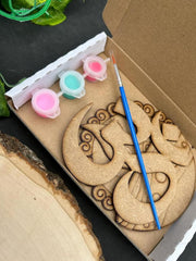 Wooden dragon ornament with paint supplies in a box