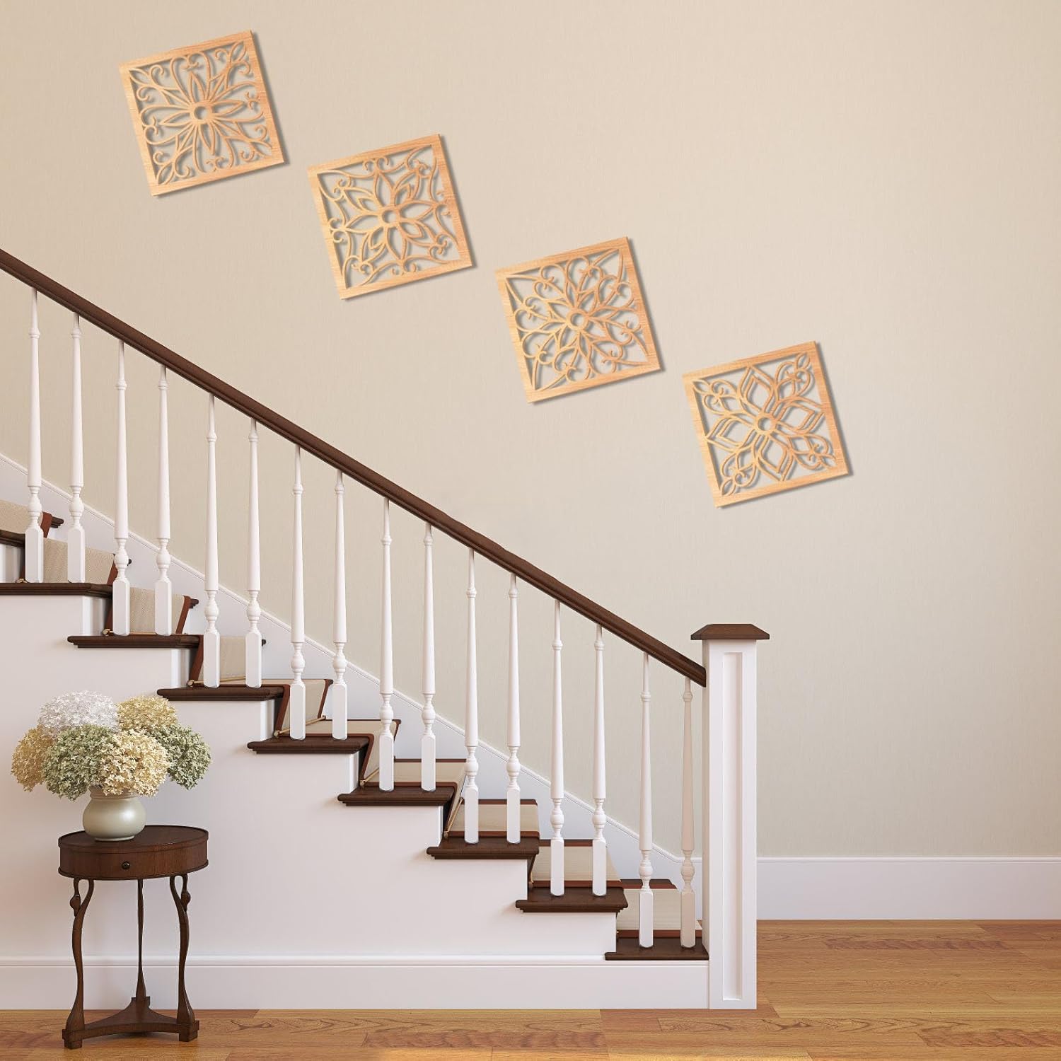 Decorative wall art above a staircase with a side table and flowers.