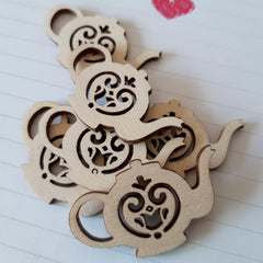 Wooden decorative piece with intricate cut-out patterns on a white surface