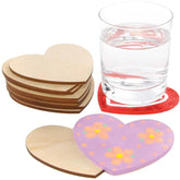 Heart-shaped wooden coasters with a glass of water on a red felt coaster.