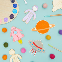 Colorful space-themed paper cutouts on a light blue background