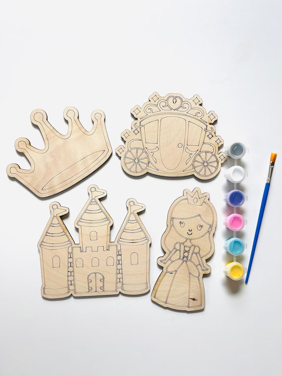 Wooden princess-themed cutouts with paint supplies on a white background