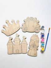 Wooden princess-themed cutouts with paint supplies on a white background