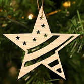 Wooden star-shaped ornament with cut-out stars on a Christmas tree.