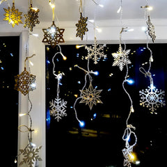 Decorative string lights with snowflake designs against a dark background