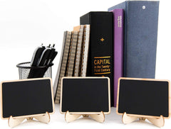 Three small blackboards on stands with books and a pen holder in the background.
