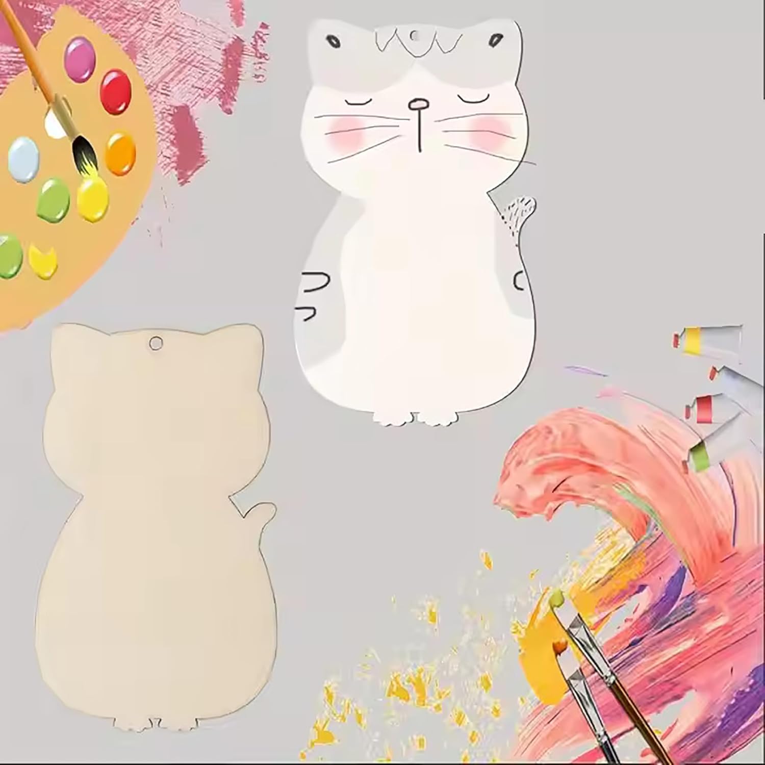 Two cat-shaped wooden boards with paint splashes and a paint palette on a gray background