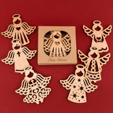 Wooden angel decorations with a 'Merry Christmas' box on a red background